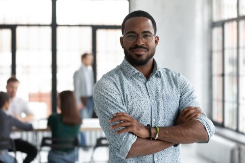 Head shot portrait confident young African American businessman wearing glasses looking at camera, successful executive startup founder standing in modern office room with arms crossed SSUCv3H4sIAAAAAAAACmxSTW/UMBD9K8U3pDWKHSex98y/aKrKX9kNTeIocaBVtVLLFSQ4Ig6V4I5URJEqqvIbnH/EONuqAnGINfP85o3nTc6RkmOt0foc1U0zjX6QvnYdWicrNNjO2GEJram9G2rZLJmSXm872Vq07qam2a3Q6KWfRjuCDmRaersB+pI/Njg8jzhaIwT0ScVgt/oPdrRCcmM7fRZrzWBlO/o6tjpERQa8QsBBKEVHO2g12MbKpfEhqlhWJDaxOCG5xSwhCZYkJ9jmghRMEKEUhdpccsU4sdikicZMpwWWRUpxJQqWxVIlNdCyIuVCMI0NtwlmhQE1YwTmlqdMWc5VSoBGlVFJRQRmAMJhDJYq0zhnlmTU0szkFmgqzzOSaYa1EgVmhFvM80RgqlhqeMZ5RSWC0U/eeDu0Dz7KydQu2vDaadkAmALYD7Wuu82e4fw2bghsdFPnh7O9lY1zvVQNeFZBmV2hrRxHIJgHIK4IVu3avUjnfDQwVhrYHEQkpYywIktFwnguMpKixx1vayiMjWIlhPqkNg/PrUEfUUklN5JibgqCo1GwBPBOV1pQY8C6RILY1DdOGr9MN24nD1MvYmhNVn9tHVJpnLJPt4SmQ7VEqt4scL91USlW2t6NtV8AeBUgWnb/cHrXmWx/5xo3Dcqd7ts0soW5IqM+9XKJWjc+icGIlRva5Ycd5AhPXryG1fTSbwF8uS7LZwfhS/garsLn8Kksw9V8EW7DD/juw3W4m9+VJU2I2J/HJDkG5q/57fwhfJ8v5vdlKZ4fhG/hJtzOl/Nl+B3uDyjIfAx34ScQL0HkPtyA6HVZZuTFq36Ddn8AAAD//wMAWDWV88QDAAA=